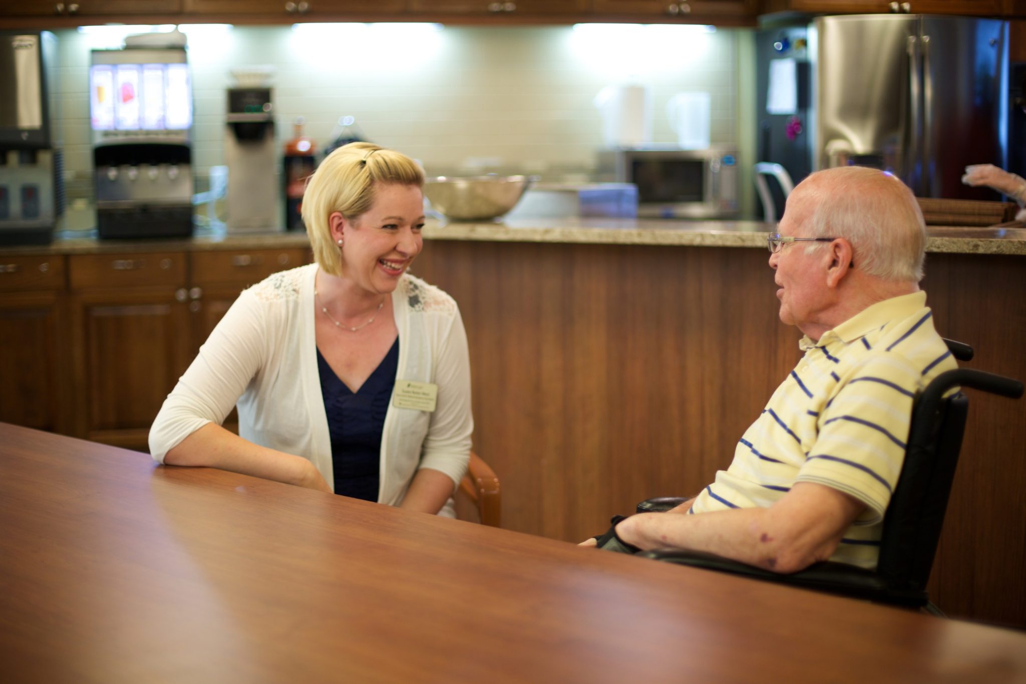 Someren Glen Senior Living Community in Centennial, CO - team member and resident chatting largelandscape